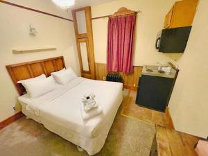 a bedroom with a large white bed and a red window at Alaskan Hotel and Bar in Juneau