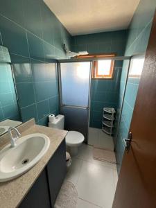 a bathroom with a sink and a toilet at Apto amplo e bem localizado! in Camaquã