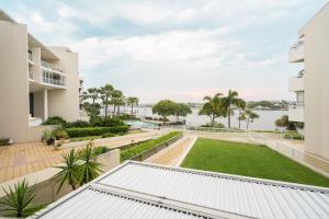 an apartment balcony with a view of the water at Riverside Retreat! Beautiful Water Views! - New Farm in Brisbane
