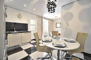 a kitchen with a table and chairs in a room at Luxury Apartment Of Split in Split