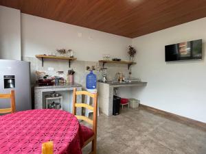 a room with a kitchen with a table and a stove at Pine Hill apartment 1 bedroom 1 bathroom in Baños