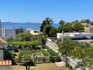 a view of a garden with the ocean in the background at Apartments with parking space Privlaka, Zadar - 21749 in Privlaka