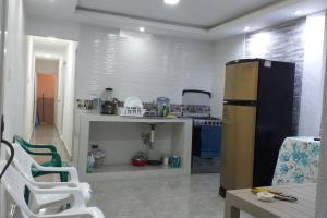 a kitchen with a refrigerator and a table and chairs at Apartamento como en casa in Soledad