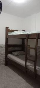 two bunk beds in a room next to a wall at Apartamento como en casa in Soledad