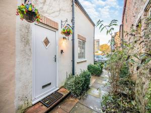 a door to a building with flowers on it at Rose Cottage - Uk45971 in Yarm