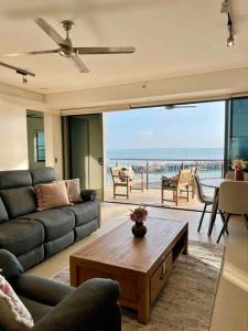 a living room with a couch and a coffee table at Sea Pearl Apartment at Waterfront in Darwin