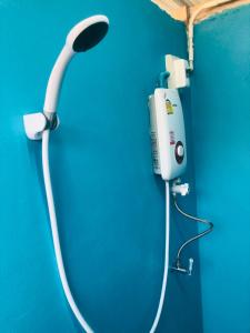 a hair dryer is attached to a blue wall at Pai Kitchen Hub Hostel in Pai