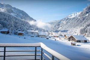a snow covered village with buildings and mountains at Chalet Alphonse - OVO Network in Châtel