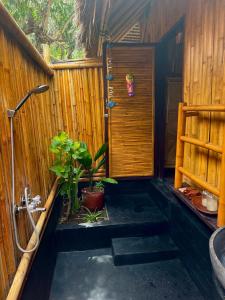 a bathroom with a shower and a toilet and a sink at Rinjani Beach Eco Resort in Tanjung