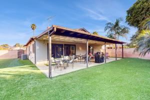 a house with a covered patio with a table and chairs at Bentons Oasis in Ventura