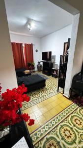 a living room with a couch and a piano at Titos Centric Home in Morelia