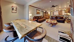 a living room with a wooden table and leather furniture at 1849 Condos 103 home in Mammoth Lakes