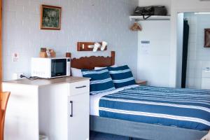 a bedroom with a bed and a computer on a desk at Avon River Inn in Stratford