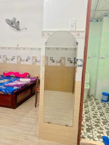 a small room with a bed and a shower at Nhà nghỉ phương nam in Ấp Rạch Mẹo