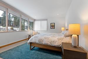a bedroom with a bed and a table with a lamp at Stellar Ski In Ski Out # 2 Northstar Townhome, HOA Amenities in Truckee +30 photos