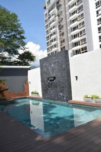 a swimming pool in front of a tall building at Nuevo apartamento en Stanza in San Pedro Sula