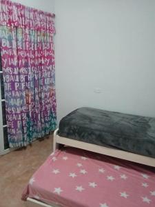 En eller flere senge i et værelse på Casa Paraná