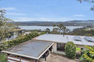an image of a house with a view of a lake at The Woodpecker in Merimbula
