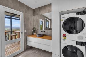 a laundry room with a washer and dryer at The Woodpecker in Merimbula