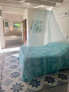 a bedroom with a bed with a mosquito net at Tapunui Spacious Retreat with Superfast Internet in Arorangi