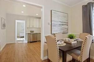 a dining room and living room with a table and chairs at Spacious 3Bdr Home close to Manhattan Beach in Lawndale
