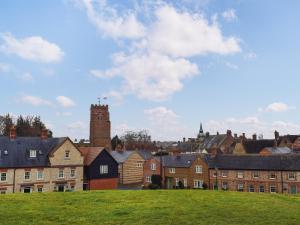 a view of a town with houses and a tower at Racing Retreat in Towcester