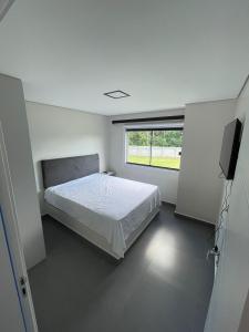 Ένα ή περισσότερα κρεβάτια σε δωμάτιο στο Chácara Fressatto