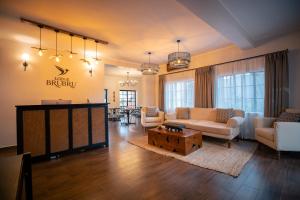 a living room with a couch and a table at Brubru Lodge in Moshi