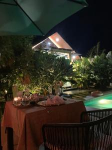 a table with food and drinks on it at night at Larue Pocket Villa in Calatagan