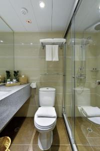 a bathroom with a toilet and a shower at The Shai Red - formerly Mingle in The Shai in Hong Kong