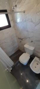 Un baño con un inodoro blanco y un lavabo. en Ru Apartamentos, en Valeria del Mar 5 fotos más