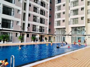 a group of people in a swimming pool in a building at OSIMI Apartment - 1 Bedroom - A0817 in Phú Mỹ