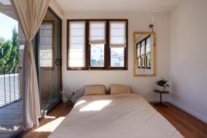 a bedroom with a bed and a large window at Dalaha Retreat in Da Thien