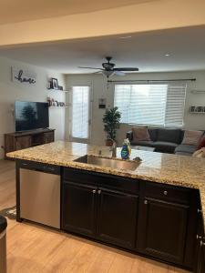 a kitchen with a sink and a living room at 3238 Correll Way in Rancho Cordova