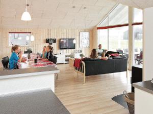 a group of people sitting in a living room at Luxury Beach House for 14 - By Traum Ferienwohnungen in Løkken +33 photos