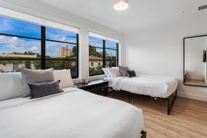 a bedroom with two beds and a large window at Lux Retreat By Renzzi in Miami +121 photos