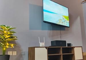 a flat screen tv hanging on a wall at 2BR Apartment in Port Dickson Bayu Beach Resort in Port Dickson