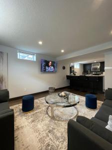 a living room with a couch and a table at TheLux Den in Yorkton