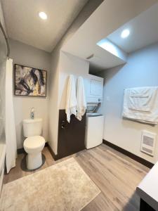 a bathroom with a toilet and a sink at TheLux Den in Yorkton