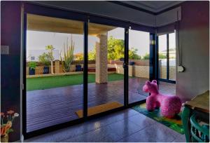 a pink elephant sitting on the floor of a house at Sunny Ocean View Retreat in Perth