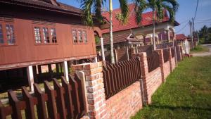 a fence in front of a house at Nuruls Homestay in Kuala Terengganu