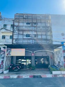 a building with a parking lot in front of it at Rabbitel Phuket in Phuket