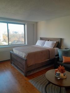 a bedroom with a bed and a large window at Luxury Fully Furnished Studio Condo in Atlanta