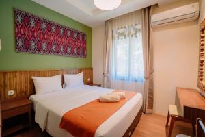 Postel nebo postele na pokoji v ubytování Mutiara Carita Cottages + 91 fotografií