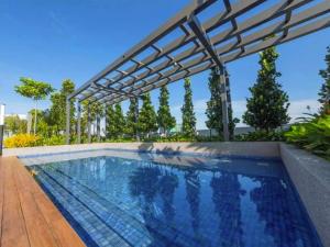 a swimming pool with a pergola on a house at Sunway Grid Cosmo Suite WI-FI 6pax BigBOX Legoland in Kampong Pendas