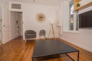 ein Wohnzimmer mit einem Tisch und zwei Stühlen in der Unterkunft Ma Pref de Miss K in Mâcon