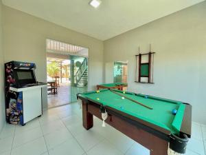 a living room with a pool table and a tv at Pousada Beach House Dunas in Beberibe