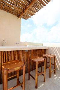 a kitchen with two stools and a bar with a view at Akbal Tulum in Tulum
