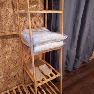 a wooden shelf with folded towels on it at SUNZI BOUTIQUE HOSTEL : ซันซิ บูทีค โฮสเทล in Betong