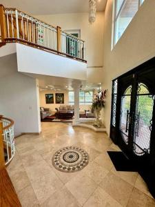 a large room with a staircase and a living room at Luxe Oasis: w/Pool & Lake Access in Nassau